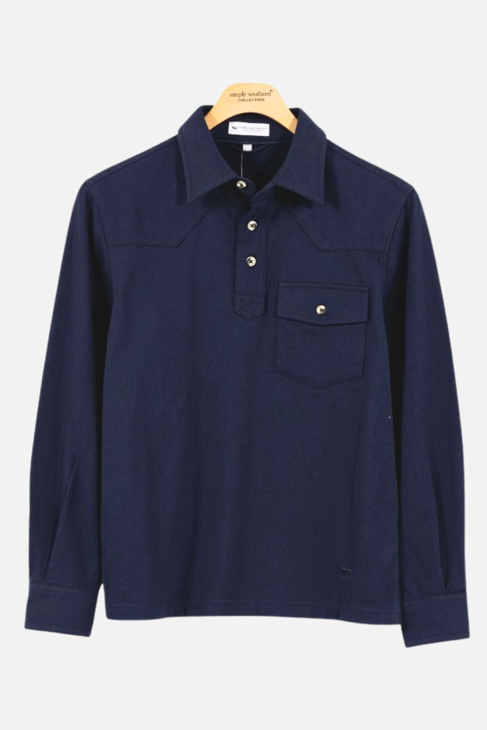 A dark navy blue long-sleeve polo shirt with a pointed collar, three-button placket, and a chest pocket with a snap closure, hanging on a wooden hanger against a light gray background.