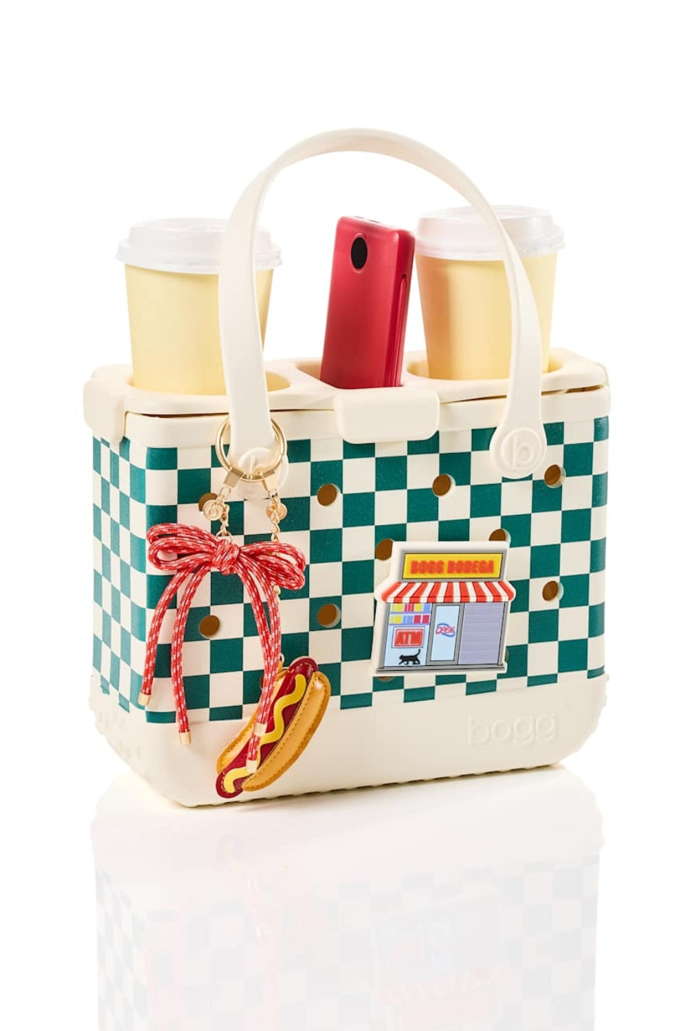 A woven tote bag featuring a green and cream checkerboard pattern with solid cream handles and base, shown on a clean white background.