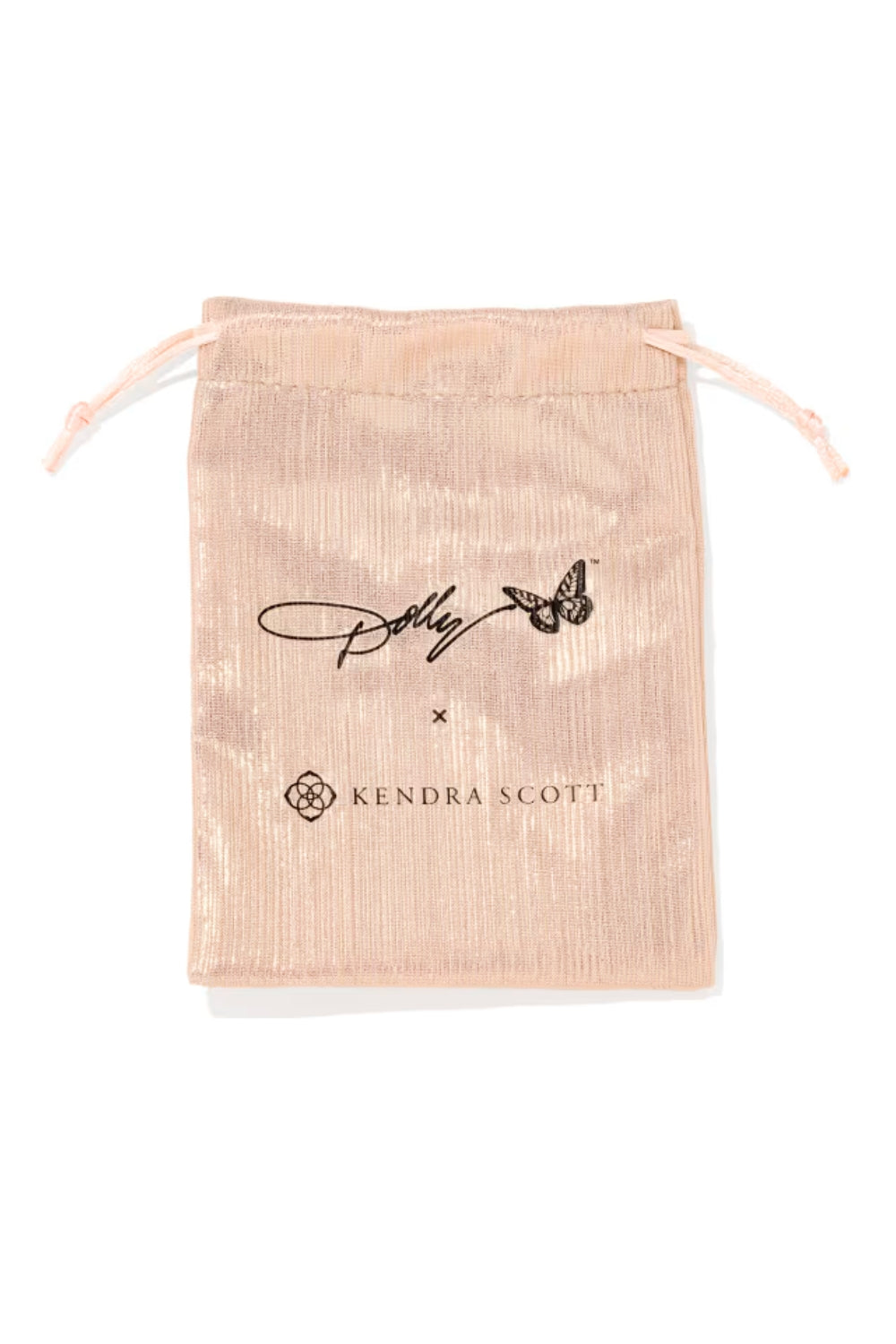A metallic blush pink drawstring pouch featuring a black printed signature and the Kendra Scott logo, set against a plain white background.