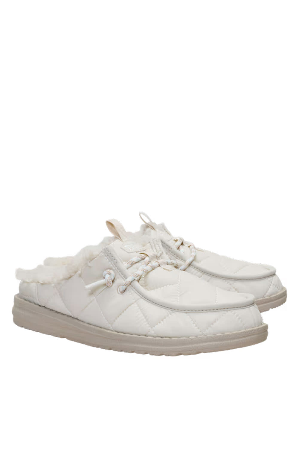 A pair of white quilted slip-on mules with faux fur lining and white laces, shown against a plain white background.